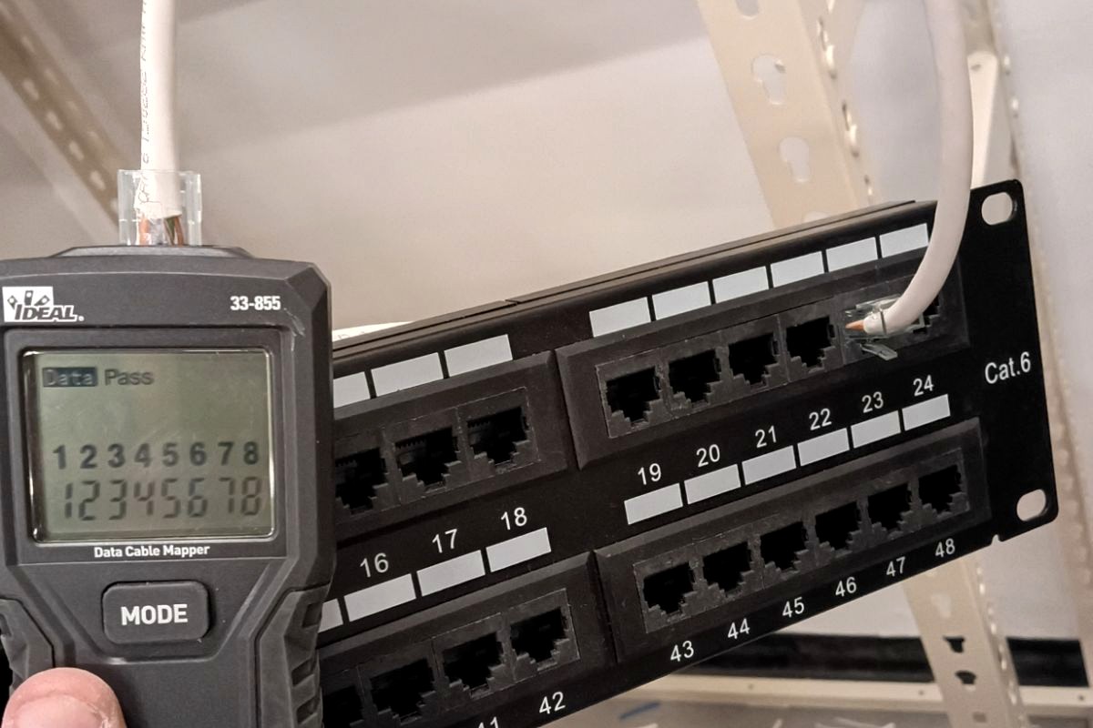 Armada technician testing structured cabling at a patch panel